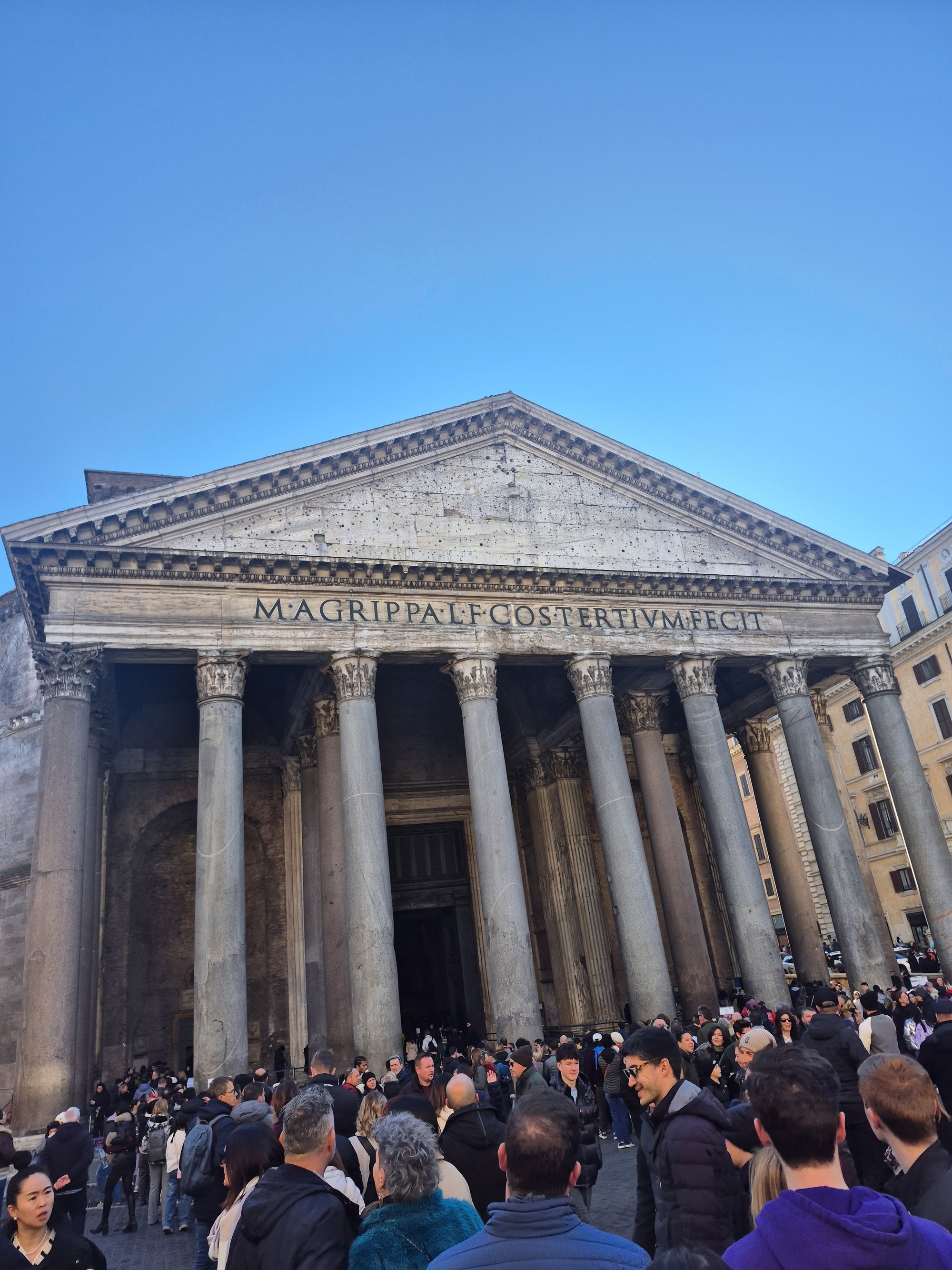 The Pantheon's portico from the piazza, M·AGRIPPA·L·F·COS·TERTIVM·FECIT across the pediment, a winter crowd filling the square